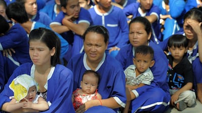 Female inmates and their children await food donations from a local aid agency at Prey Sar prison in Phnom Penh, in a file photo. AFP