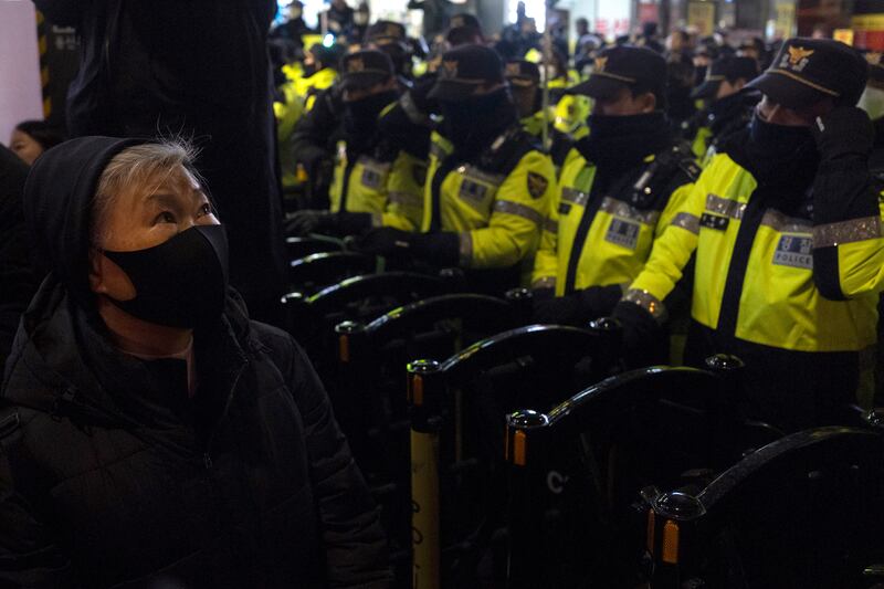 2024年12月4日，韩国首尔，警察阻挡抗议游行。(AP Photo/Ng Han Guan)