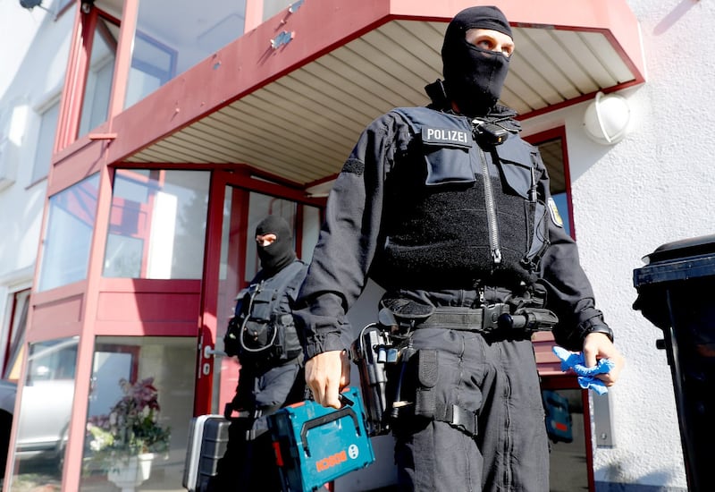 German police, including the GSG9 special operations police unit, leave a building as they raid sites across the country in a crackdown on human trafficking and forced prostitution in Maintal, Germany, in 2018. Credit: Reuters