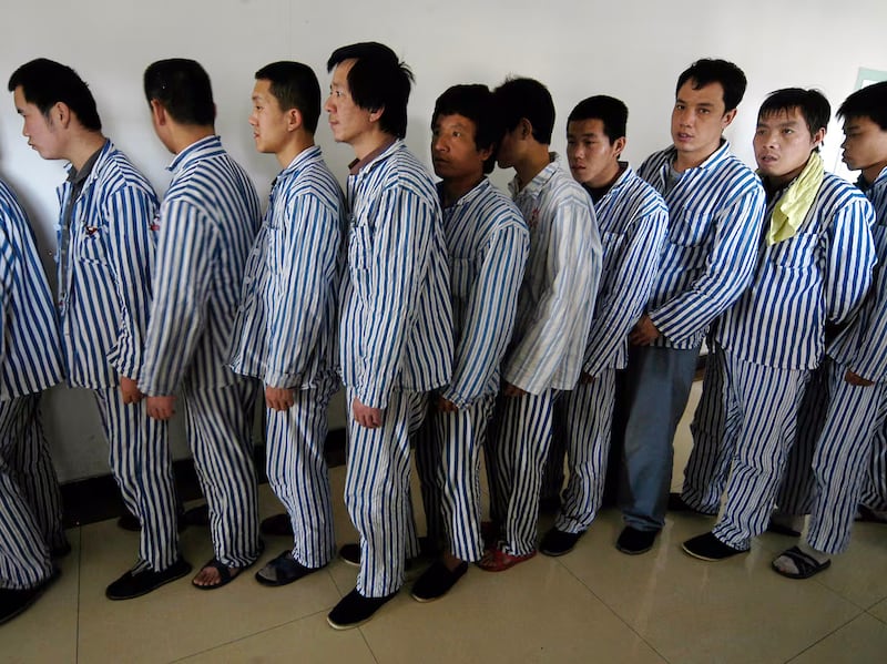 Patients wait to enter an activity room at a psychiatric hospital in Changzhi, Shanxi province, China, May 18, 2007.