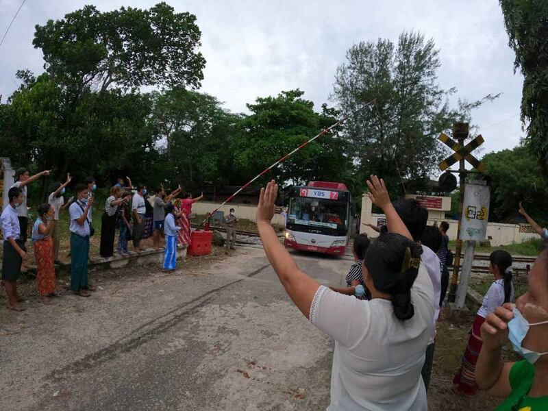 A bus with released prisoners onboard is driven out of Insein Prison in Yangon on Wednesday. (Myo Min Soe/RFA)