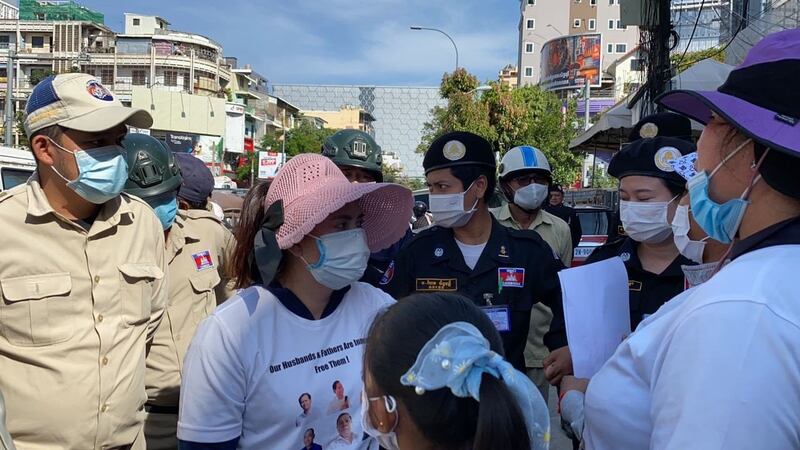 Security forces confront members of the 'Friday Wives' group outside of the Phnom Penh Municipal Court in Phnom Penh, Jan. 8, 2021.