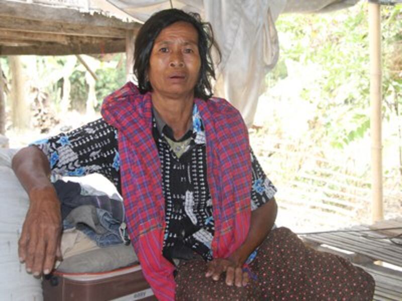 Ut Troeuk sits in her home in Mesang village in southeastern Cambodia's Prey Veng province, Jan. 29, 2016.