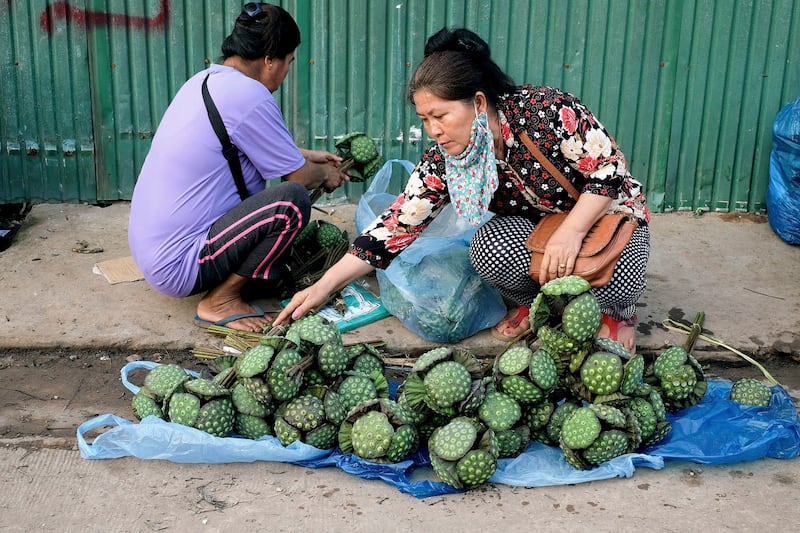 Vendors sell lotus flower seeds at Khua Din market in Vientiane, Laos, PDR. Credit: In Pictures Ltd./Corbis via Getty Images file photo