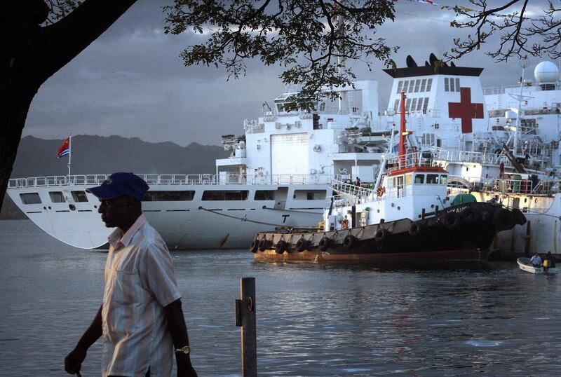 A file photo showing a man walking past a Chinese hospital ship moored in the harbor of the Fiji capital of Suva Aug. 24, 2014. The U.S. is looking to step up its engagement with Pacific islands amid strategic competition with China. Credit: Reuters