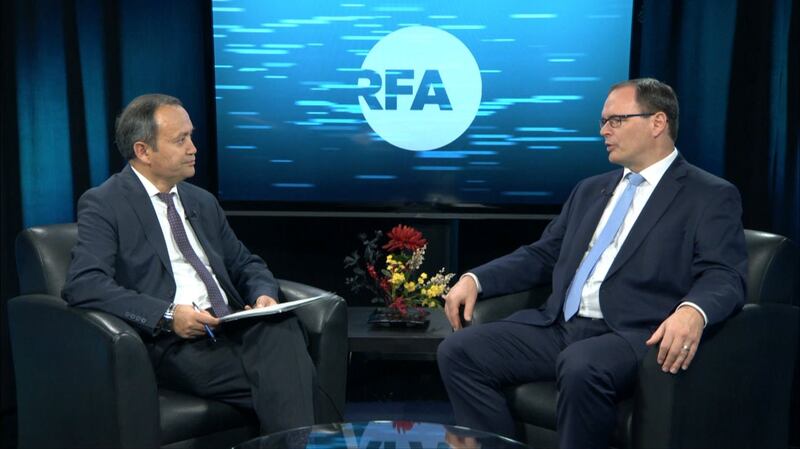 Adrian Zenz (R) speaks with RFA's Alim Seytoff (L) during an interview in Washington, Nov. 8, 2019. RFA