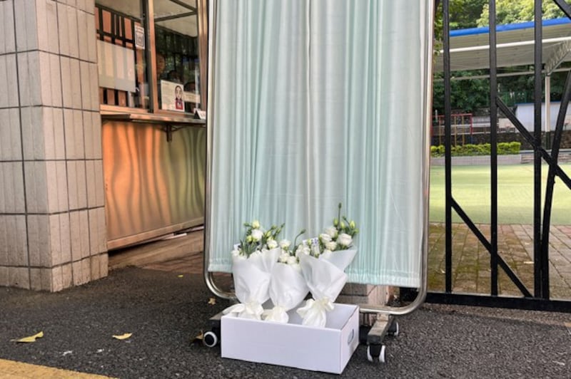 Flower bouquets lie outside the Shenzhen Japanese School in Shenzhen, Guangdong province, China, Sept. 19, 2024. (David Kirton/Reuters)