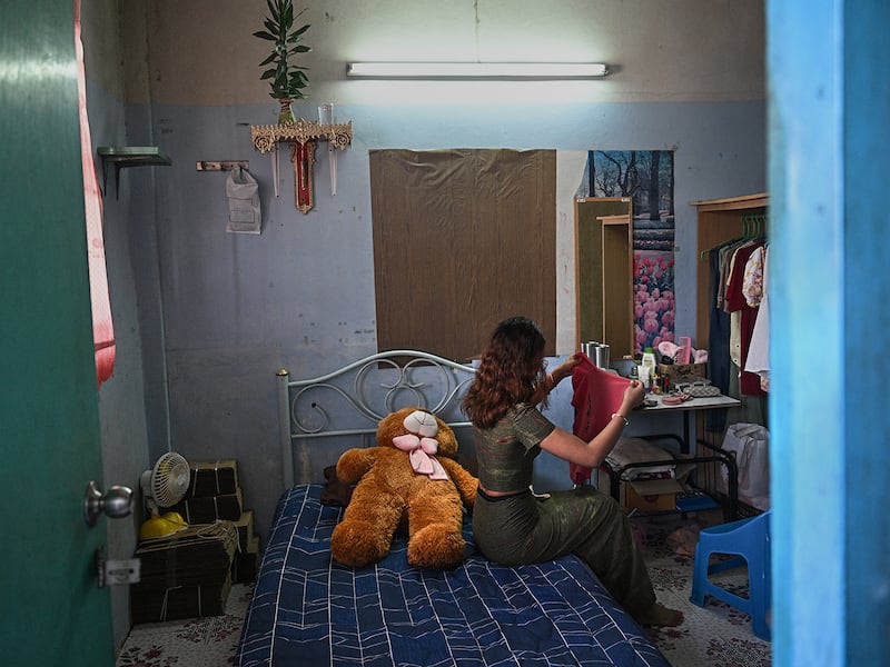 "Khaing," a former teacher with the Civil Disobedience Movement folds clothes at her current home in Bangkok, Thailand,  June 4, 2024, after fleeing Myanmar to avoid conscription by the military junta.