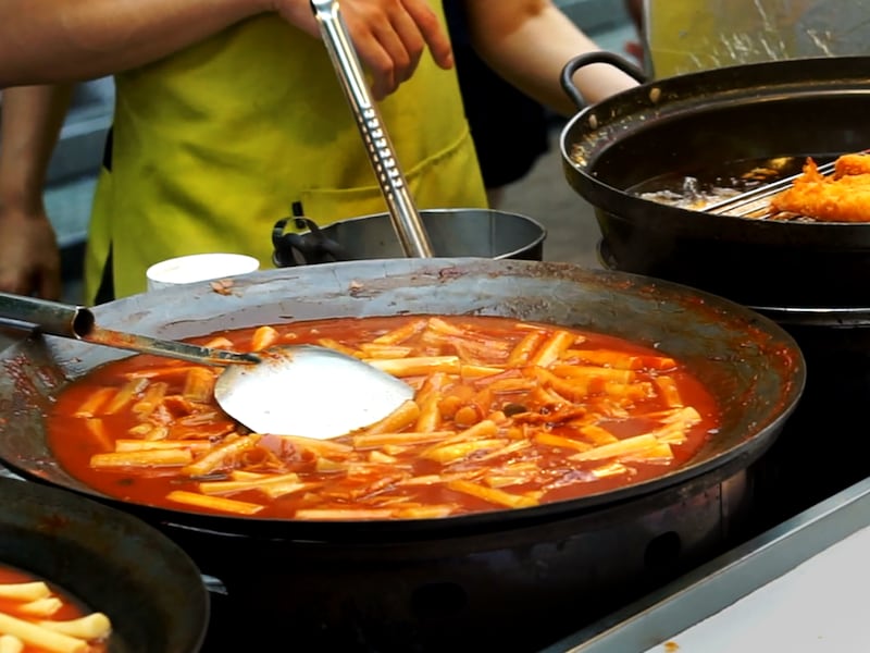 Tteokbokki is served at a Korean street food stall.