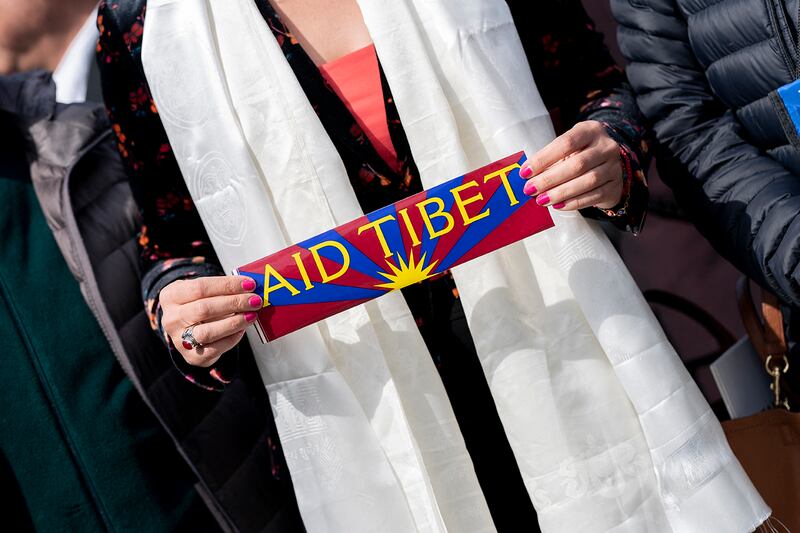 A person holds an “Aid Tibet” sticker before a press conference to highlight the plight of Tibetans, on Capitol Hill in Washington, D.C., on March 28, 2023.