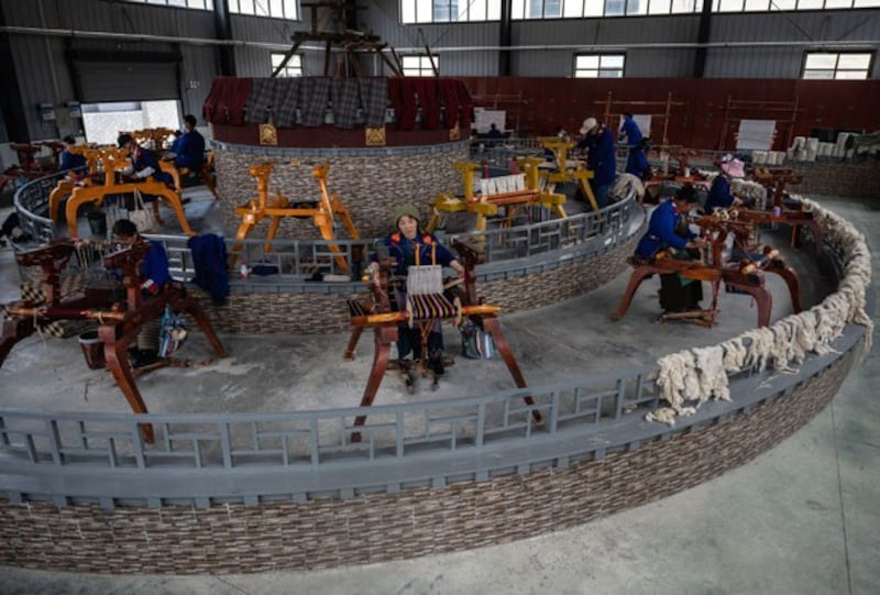 Tibetan workers make traditional items on looms at the National Huaji Handweaving Cooperative in Lhoka, also known as Shannan, in western China's Tibet Autonomous Region, June 19, 2023. (Kevin Frayer/Getty Images)