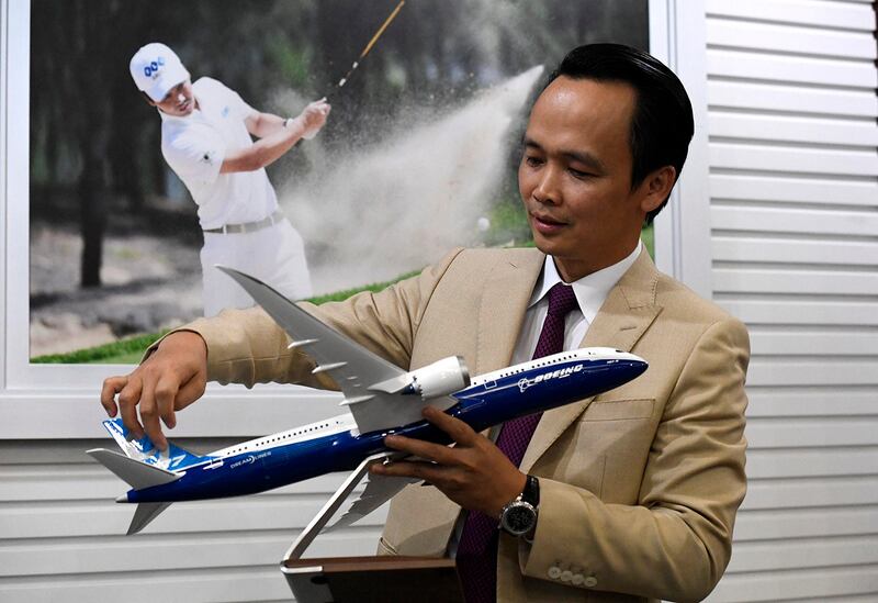 FLC Group CEO Trinh Van Quyet holds a model of a Boeing Dreamliner passenger jet at his office in Hanoi, July 30, 2018. (Nhac Nguyen/AFP)