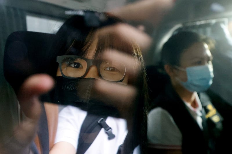 Human rights lawyer Chow Hang-tung is seen inside a vehicle after being detained in Hong Kong, Sept. 8, 2021.