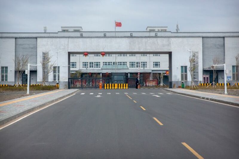 Police officers stand at the outer entrance of Urumqi No. 3 Detention Center in Dabancheng in northwestern China's Xinjiang region, April 23, 2021. (Mark Schiefelbein/AP)