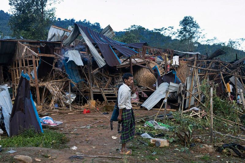 A man looks on at homes destroyed after air and artillery strikes in Mung Lai Hkyet displacement camp in northern Kachin state, Oct. 10, 2023. (AP Photo)