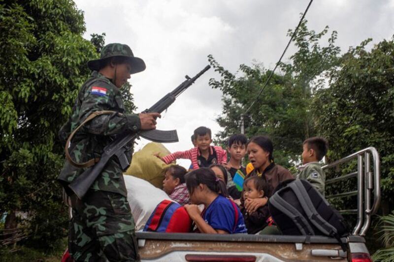 A member of the Karenni Nationalities Defense Force rescues civilians trapped amid airstrikes during the battle for Loikaw in eastern Myanmar's Kayah State, Nov. 14, 2023. (Reuters)