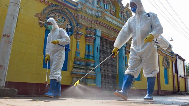 Myanmar military personnel wearing protective clothing disinfect a Hindu temple as a preventive measure to contain the spread of the coronavirus in the capital Naypyidaw, April 1, 2020.