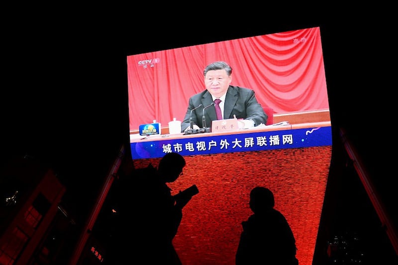 China's President Xi Jinping is seen in a big screen during an evening news program at a mall in Beijing on November 11, 2021, as top Communist Party leaders wrapped up a key meeting by passing an important resolution which is expected to cement his grip on power. Credit: AFP