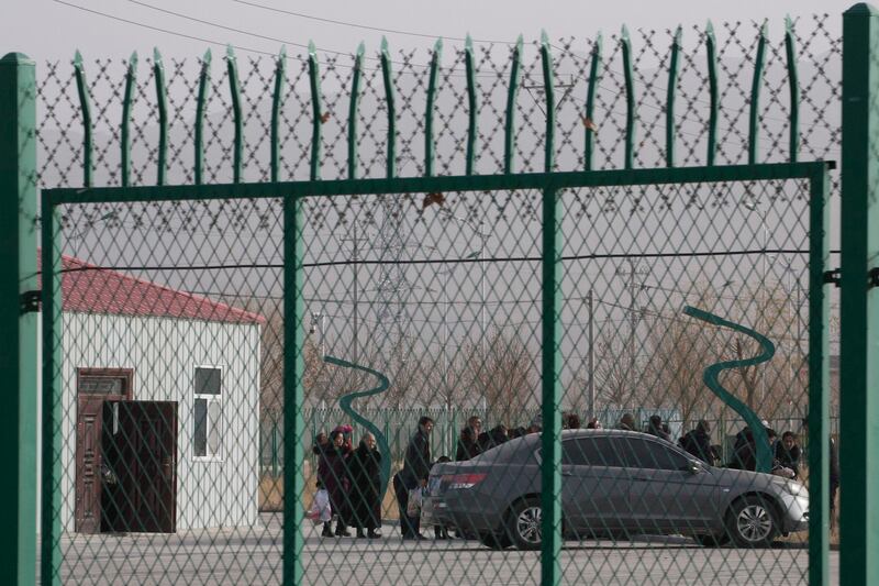 In this Dec. 3, 2018 photo, residents line up inside the Artux City Vocational Skills Education Training Service Center which has previously been revealed by leaked documents to be a forced indoctrination camp at the Kunshan Industrial Park in Artux in western China's Xinjiang region. (Ng Han Guan/AP)