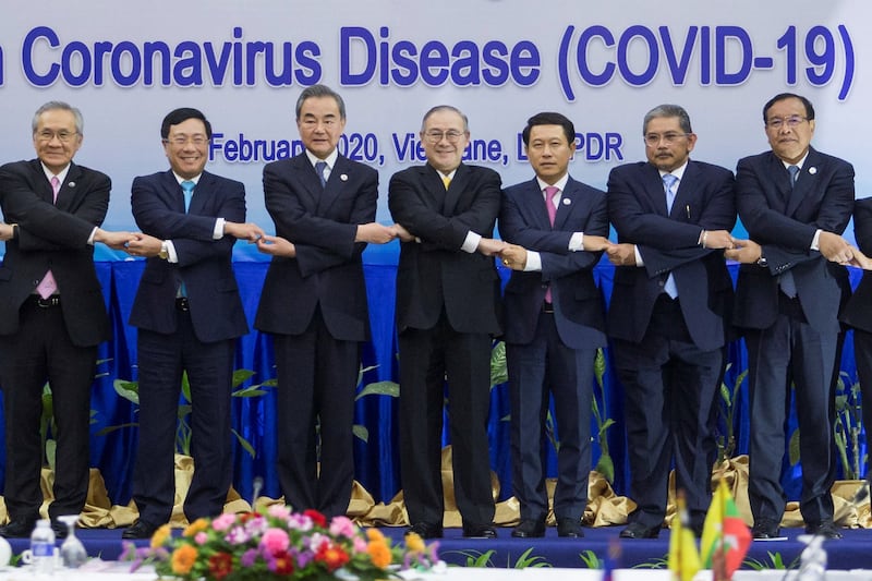 A file photo showing ASEAN foreign ministers posing with China's Foreign Minister Wang Yi at a meeting in Vientiane, Laos, about the COVID-19 pandemic, Feb. 20, 2020. Credit: Reuters