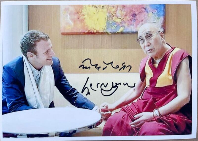 An autographed photo of the Dalai Lama (R) and French President Emmanuel Macron during a September 2016 meeting. (Sikyong Penpa Tsering via Twitter)