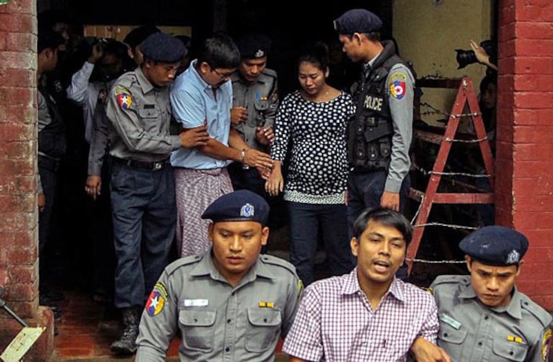 Detained Myanmar journalists Kyaw Soe Oo (front-C) and Wa Lone (back-2nd from R) are escorted by police from a courthouse following a hearing in Yangon, Myanmar, July 9, 2018.