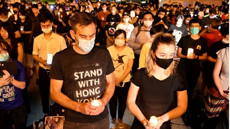 People hold candles in front of the Chiang Kai-shek Memorial Hall, also known as Free Square, to mark the 31st anniversary of the 1989 Tiananmen Square crackdown in Taipei, June 4, 2020.