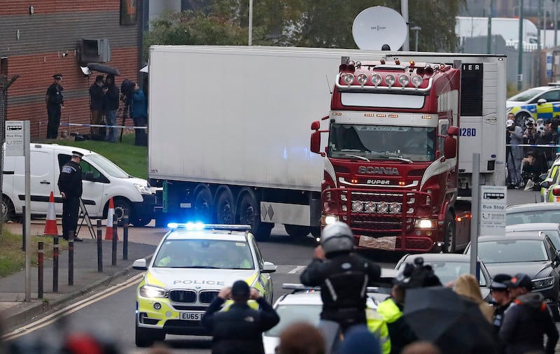 Police escort a truck that was found to contain the bodies of nearly 40 Vietnamese migrants as they move it from an industrial estate in Thurrock, England, Oct. 23, 2019. (Alastair Grant/AP)