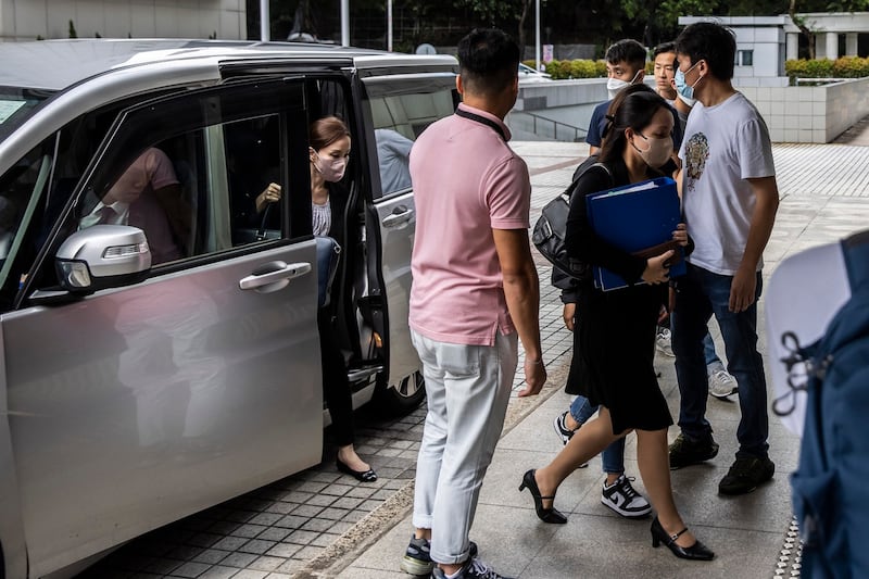 A government prosecutor [center, right] arrives at the High Court in Hong Kong on July 21, 2023, as the government seeks an injunction to have the protest song “Glory to Hong Kong” banned. Credit: Isaac Lawrence/AFP