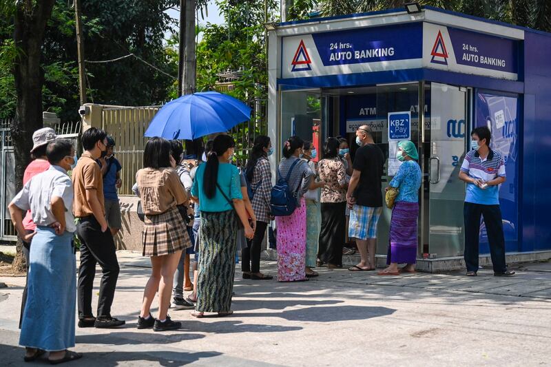 People queue as they wait to use ATMs in Yangon, April 7, 2021. AFP