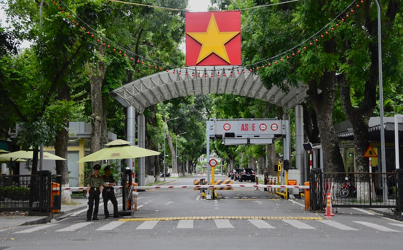 Police officers stand guard outside government buildings in Hanoi, Aug. 22, 2024.