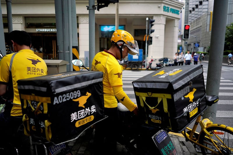 Employees of Chinese online shopping platform Meituan prepare deliveries in Shanghai, in a file photo. Credit: Reuters