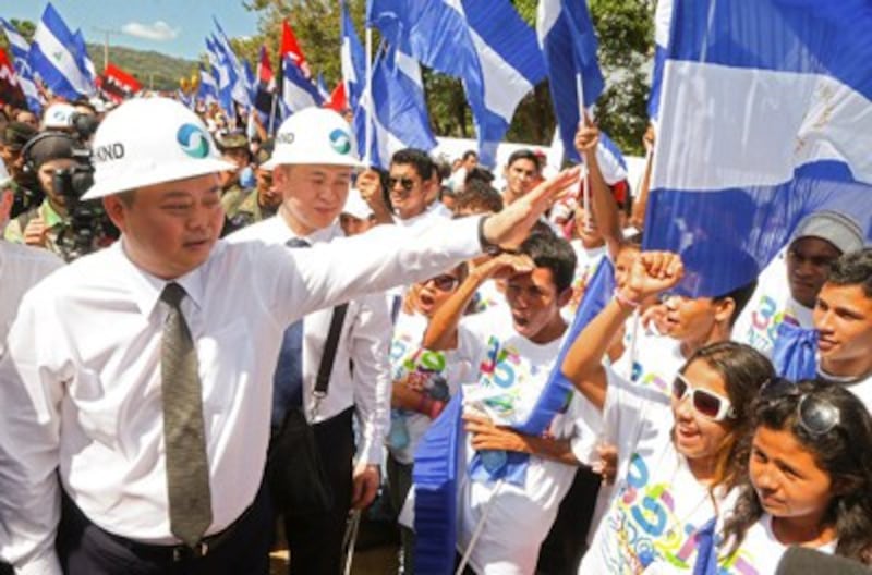 Chinese businessman Wang Jing (L) of HKND greets members of the Sandinista National Liberation Front at the canal project's groundbreaking ceremony in Tola, Nicaragua, Dec. 22, 2014. Credit: AFP