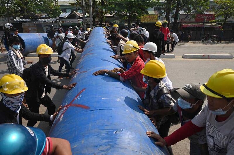 Protesters used anything they could get their hands on - such as this length of pipe - to protect themselves. (AFP)