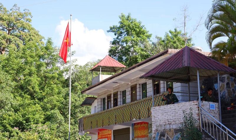 A member of the Myanmar National Democratic Alliance Army takes sentry duty near the flagpole flying the MNDAA's flag at the border trading gate in Chinshwehaw town, Myanmar, Oct. 29, 2023. Credit: The Kokang via AP