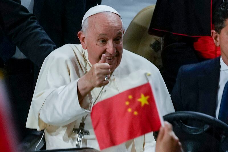 A person waves a Chinese flag as Pope Francis cheers upon arriving to preside over a mass in Ulaanbaatar, Mongolia, Sept. 3, 2023.