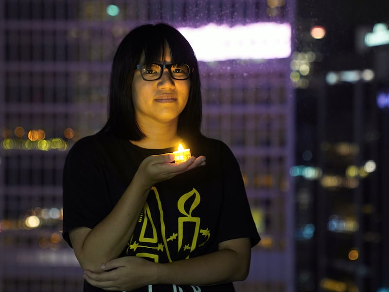 Chow Hang-tung poses with a candle in Hong Kong,  June 3, 2021, ahead of the 32nd anniversary of the crackdown on pro-democracy demonstrators at Beijing's Tiananmen Square in 1989,