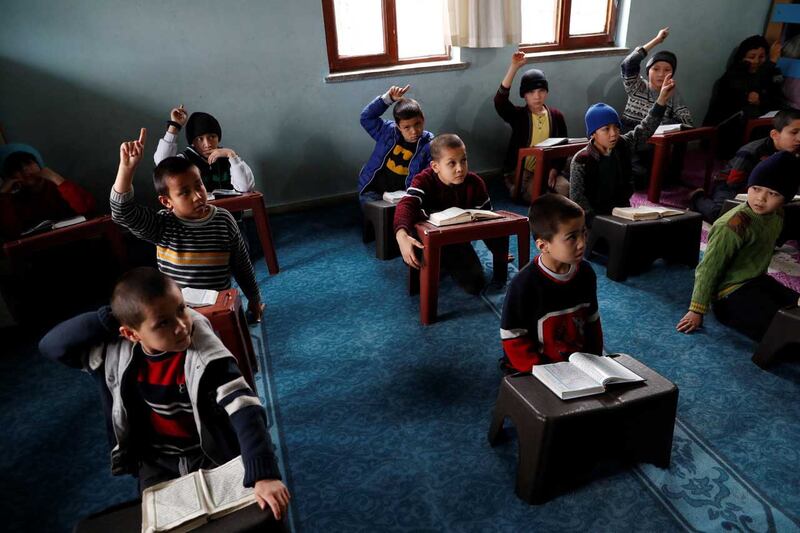 Uyghur boys who have lost a parent in China's Xinjiang region raise their hands during a Qu'ran class in a madrasa, or religious school, in Kayseri, Turkey, Jan. 31, 2019. Credit: Reuters