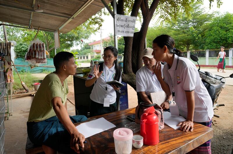 Census enumerators ask questions to a man in Naypyitaw as Myanmar holds a national census to compile voter lists, Oct. 1, 2024. (Aung Shine Oo/AP)