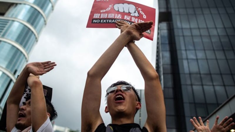 Protesters gesture as they chant "no extradition" as they rally against a controversial extradition law proposal in Hong Kong, June 9, 2019.