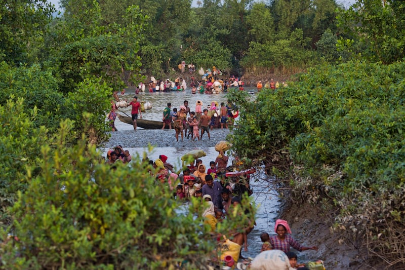 Groups of Rohingya cross the Naf river at the border between Myanmar and Bangladesh, near Palong Khali, Bangladesh, Nov. 1, 2017.