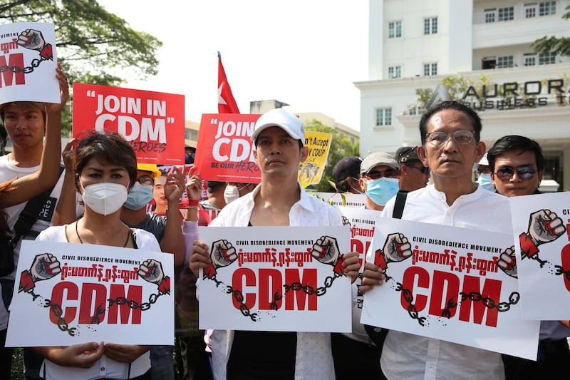 Anti-military junta protesters trying to enlist civil servants to join nationwide demonstrations rally in Myanmar's largest city, Yangon, Feb. 15, 2021.