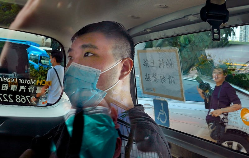 Tong Ying-kit arrives at a court in a police van in Hong Kong, July 6, 2020, days after arrest for driving his motorbike into a group of police officers while carrying a flag bearing the protest slogan “Liberate Hong Kong." Credit: AP