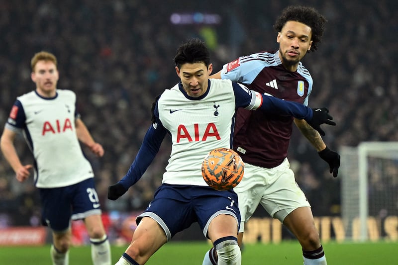 Tottenham Hotspur's South Korean striker Son Heung-Min, center, and Aston Villa's French midfielder Boubacar Kamara, right, fight for the ball during the English FA Cup fourth round football match between Aston Villa and Tottenham Hotspur in Birmingham, England, Feb. 9, 2025.