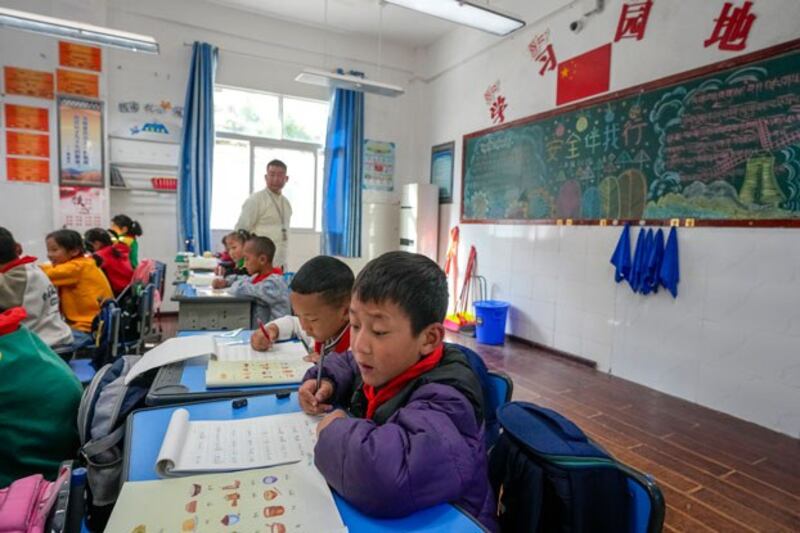 Tibetan students learn Tibetan writing in a first-grade class at the Shangri-La Key Boarding School during a tour organized for media in Dabpa county, Kardze Prefecture, in southwest China's Sichuan province, Sept. 5, 2023. (Andy Wong/AP)