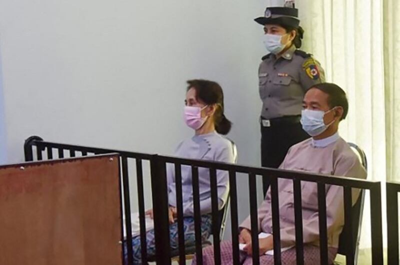 Detained Myanmar State Councilor Aung San Suu Kyi (L) and president Win Myint (R) during their first court appearance in Naypyidaw, May 24, 2021. Credit: Myanmar's Ministry of Information via AFP