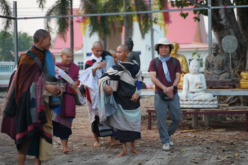 Vietnamese monk Thich Minh Tue, center, walks during alms rounds in Nong Bua, Nakhon Sawan province, Thailand, Feb. 13, 2025.