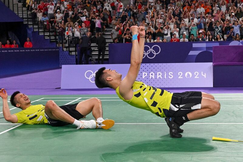 Taiwan's Lee Yang and Wang Chi-lin celebrate winning the men's doubles badminton final match against China during the Paris 2024 Olympic Games at Porte de la Chapelle Arena in Paris, Aug. 4, 2024. (Arun Sankar/AFP)