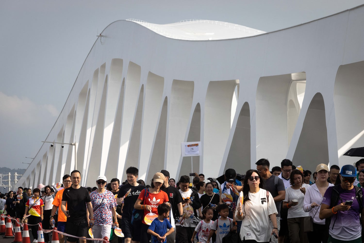 People walk on the newly opened Macau Bridge, the fourth connection between the Macau peninsula and Taipa island, in Macau on Sept. 29, 2024.