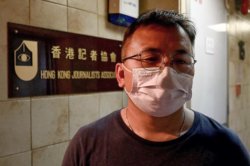 Ronson Chan, chairman of the Hong Kong Journalists Association, standing outside his office in Hong Kong, Jan. 7, 2022. Credit: AFP